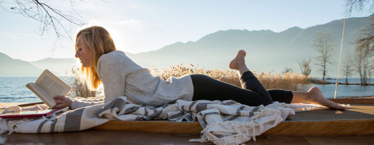 Girl reading on blanket
